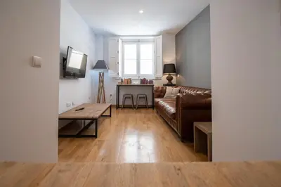a living room with a couch and a table at Kotinousa Cádiz - Centro historico in Cádiz