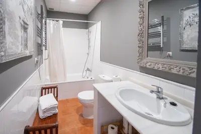 a white bathroom with a sink and a toilet at Kotinousa Cádiz - Centro historico in Cádiz