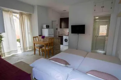 a living room with a white couch and a table at GINVA - MMS Bounty Puerto Sherry Playa in El Puerto de Santa María