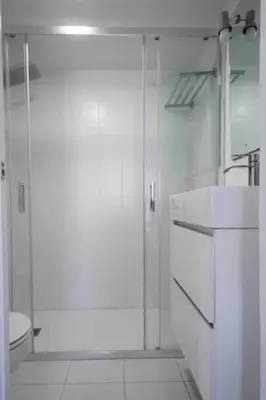 a white bathroom with a shower and a sink at GINVA - MMS Bounty Puerto Sherry Playa in El Puerto de Santa María
