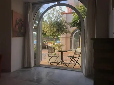 an open door to a patio with chairs and a table at GINVA - MMS Bounty Puerto Sherry Playa in El Puerto de Santa María