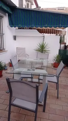 a patio with a table and chairs on a patio at Duplex convento la victoria in Sanlúcar de Barrameda