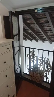 a room with a window with a plant in a basket at Duplex convento la victoria in Sanlúcar de Barrameda
