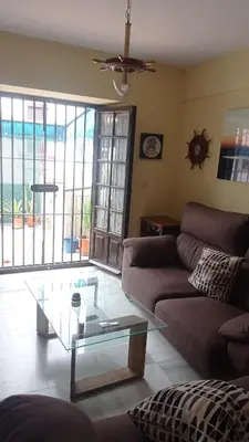 a living room with a couch and a glass table at Duplex convento la victoria in Sanlúcar de Barrameda