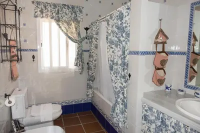 a bathroom with a toilet and a sink at Chalet Enol Sol in Chiclana de la Frontera