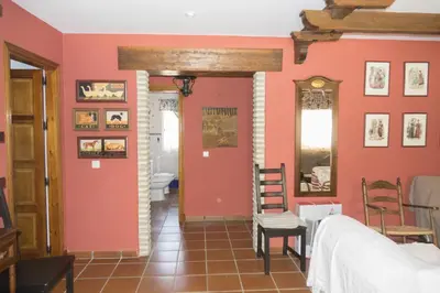 a room with pink walls and a bedroom with a bed at Chalet Enol Sol in Chiclana de la Frontera