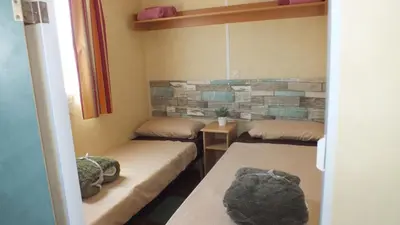 a room with three beds in a room at La Vida el Verano en Novo Sancti Petri - Casa Acogedora in Chiclana de la Frontera