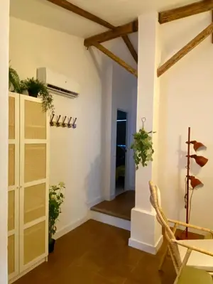a room with a table and chairs and a hallway at Casa Rural La Yeguada in Malcocinado