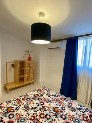 a bedroom with a bed with a blue curtain at Casa Rural La Yeguada in Malcocinado