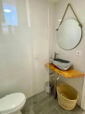 a bathroom with a toilet and a mirror at Casa Rural La Yeguada in Malcocinado