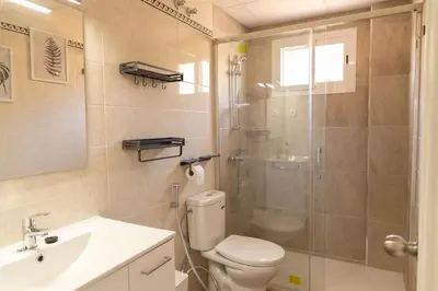 a bathroom with a toilet and a shower and a sink at El Ático del Olivarillo in San Fernando