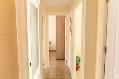 a hallway with a hallway leading into a room at El Ático del Olivarillo in San Fernando