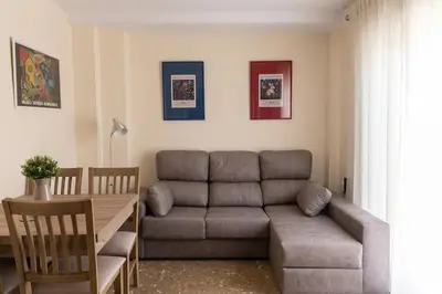 a living room with a couch and a table at El Ático del Olivarillo in San Fernando