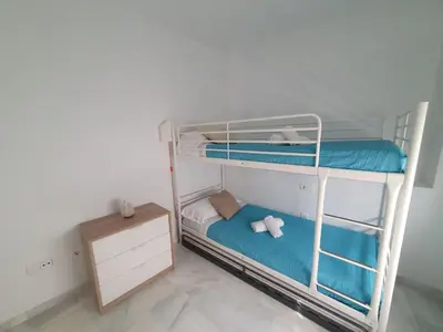 a room with two bunk beds in a room at Larga 109 in El Puerto de Santa María