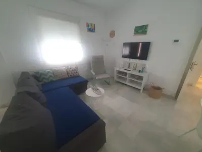 a living room with a couch and a tv at Larga 109 in El Puerto de Santa María