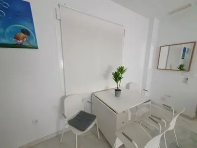 a white room with a white desk and chairs at Larga 109 in El Puerto de Santa María