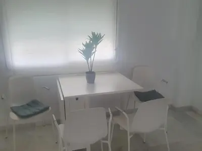 a table and chairs with a potted plant on it at Larga 109 in El Puerto de Santa María