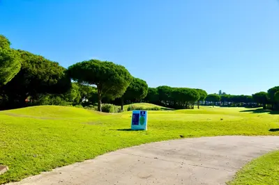 a blue box sitting in the grass next to a road at Chalet independiente en la loma in Chiclana de la Frontera
