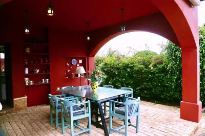 a dining room with a table and blue chairs at Chalet independiente en la loma in Chiclana de la Frontera
