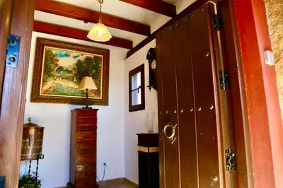 a hallway with a painting on the wall and a door at Chalet independiente en la loma in Chiclana de la Frontera