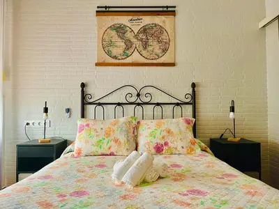 a bedroom with a bed and a mirror at Hostal El Faro in Chipiona