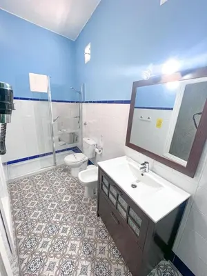 a bedroom with a bed with two towels on it at Hostal El Faro in Chipiona