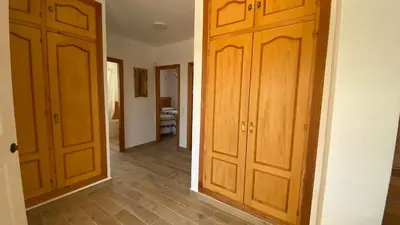 a hallway with two wooden doors in a room at Casa Juan in Conil de la Frontera