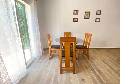 a dining room with a table and four chairs at Casa Juan in Conil de la Frontera