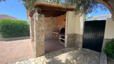 a entrance to a house with a stone wall at Casa Juan in Conil de la Frontera