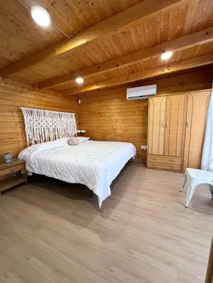 a bedroom with a bed in a wooden room at Casita de madera Azul in Chiclana de la Frontera