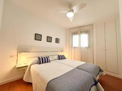 a bedroom with a bed and a ceiling fan at Ático Castillo by Summerland Rota in Rota