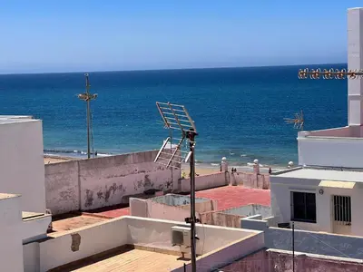 a view of the ocean from the roof of a building at Ático Castillo by Summerland Rota in Rota