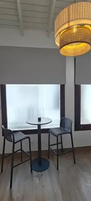 a table and two chairs in a room with a light at Los Jereles. in Jerez de la Frontera