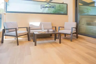 two chairs and a table in a room with a table and chairs at Apartamento Soto Verde in Sanlúcar de Barrameda