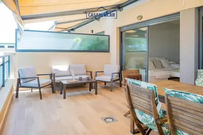 a living room with a table and chairs at Apartamento Soto Verde in Sanlúcar de Barrameda
