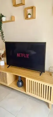 a television sitting on a wooden stand in a room at Dúplex Chiclana Centro con Terraza y Parking By Chiclana Dreams in Chiclana de la Frontera