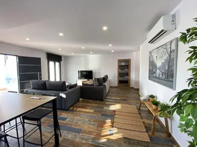 a living room with a couch and a table at Villa Romance in Chipiona