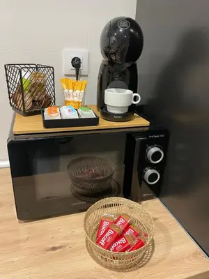 a coffee maker sitting on top of a microwave at Apartamentos Corredera 4 in Arcos de la Frontera