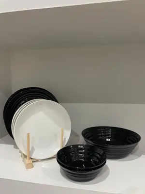 three black bowls sitting on top of a shelf at Apartamentos Corredera 4 in Arcos de la Frontera
