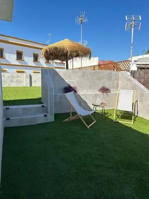 a patio with a slide and two chairs and a table at Apartamentos Corredera 4 in Arcos de la Frontera
