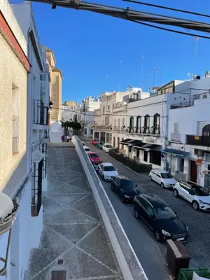 a view of a city street with parked cars at Apartamentos Corredera 4 in Arcos de la Frontera