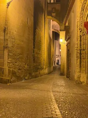 an alley in an old building at night at Apartamentos Corredera 4 in Arcos de la Frontera