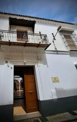 a white building with a door and a balcony at Apartamento en Casa Palacio- Centro Sanlucar in Sanlúcar de Barrameda