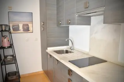 a kitchen with a sink and a counter top at Apartamento en Casa Palacio- Centro Sanlucar in Sanlúcar de Barrameda