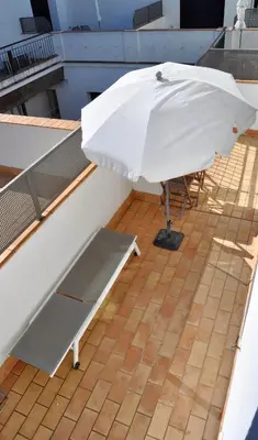 a white umbrella sitting on top of a roof at Apartamento en Casa Palacio- Centro Sanlucar in Sanlúcar de Barrameda