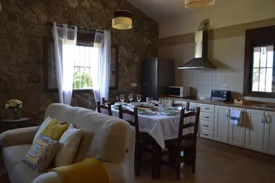 a kitchen with a table and a dining room at Las Yucas in Conil de la Frontera
