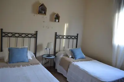 two beds sitting next to each other in a bedroom at Las Yucas in Conil de la Frontera