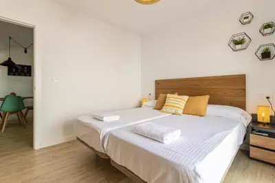 a bedroom with a large white bed with two pillows at Allo Apartments Morenos V Centro Gran Terraza in Jerez de la Frontera