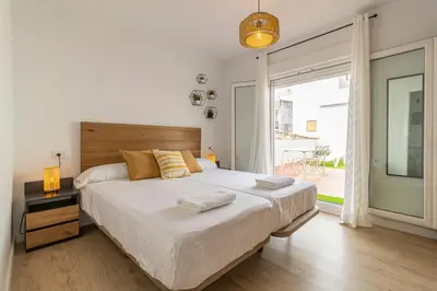 a bedroom with a large bed and a large window at Allo Apartments Morenos V Centro Gran Terraza in Jerez de la Frontera