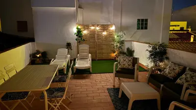 a patio with chairs and tables and a table and chairs at Allo Apartments Morenos V Centro Gran Terraza in Jerez de la Frontera